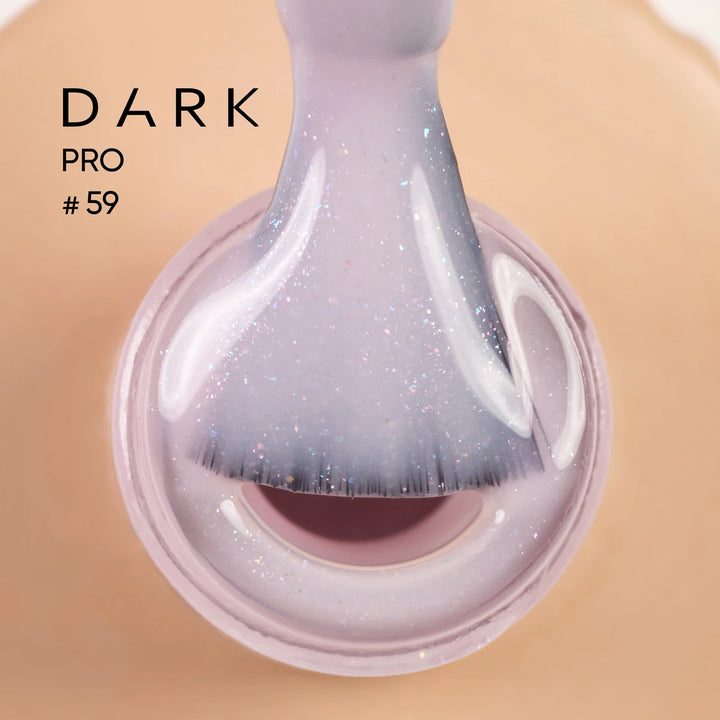 Close-up of a brush with shimmery light purple gel nail polish, labeled Dark Pro 