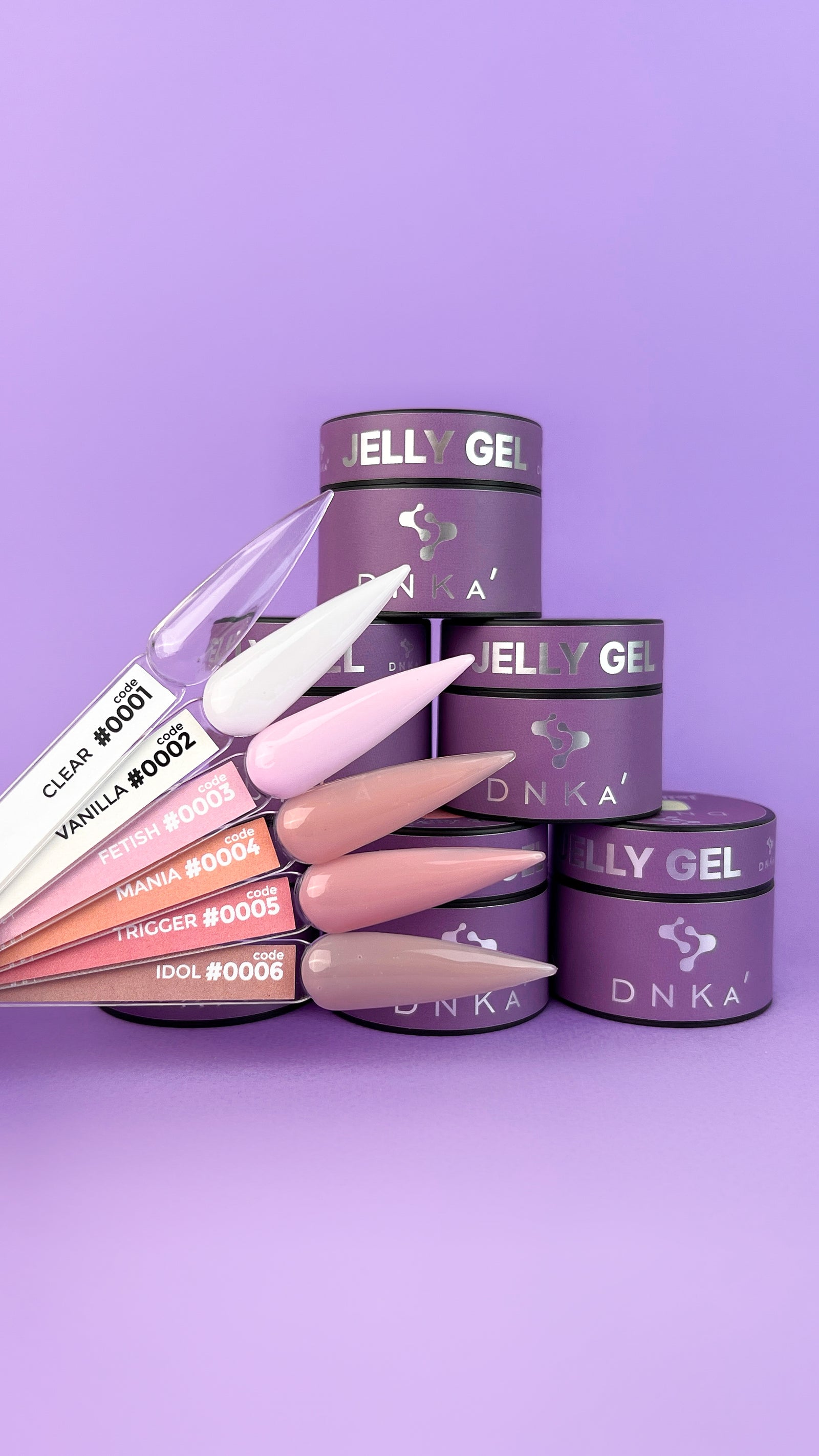 Assorted DNKA jelly gel nail polish jars with color swatches on purple background