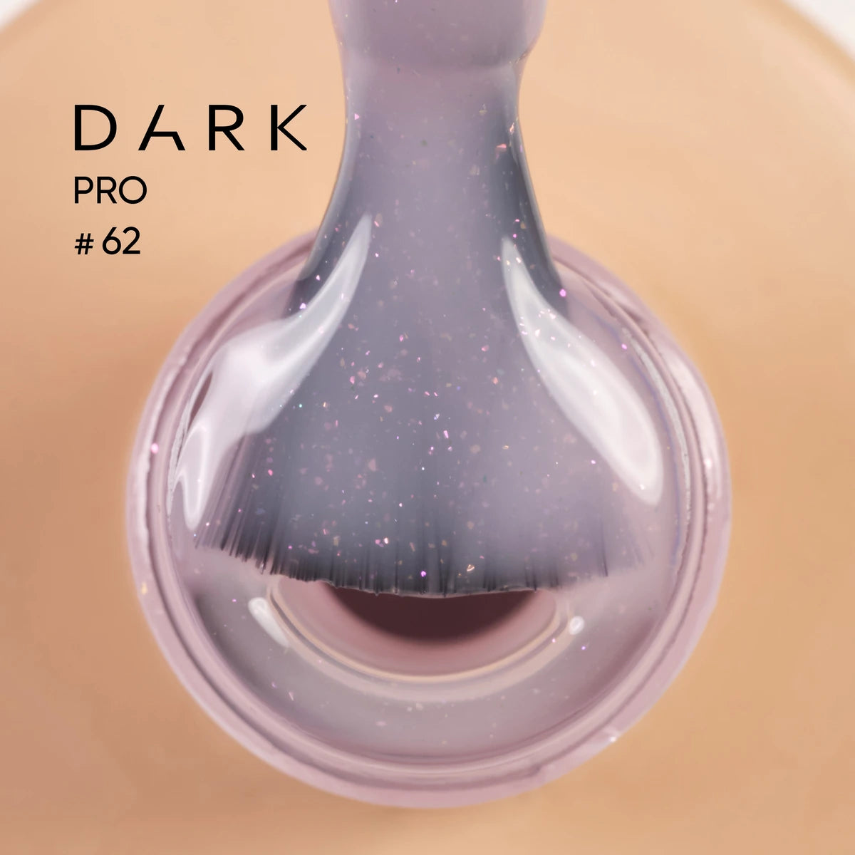Close-up of a nail polish brush with glittery purple gel polish, labeled Dark Pro #62.