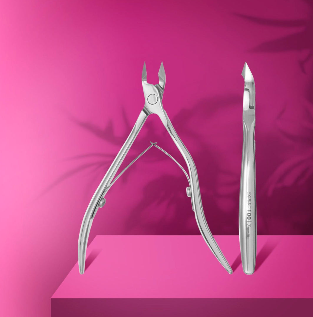 Stainless steel cuticle nipper for manicure on pink background