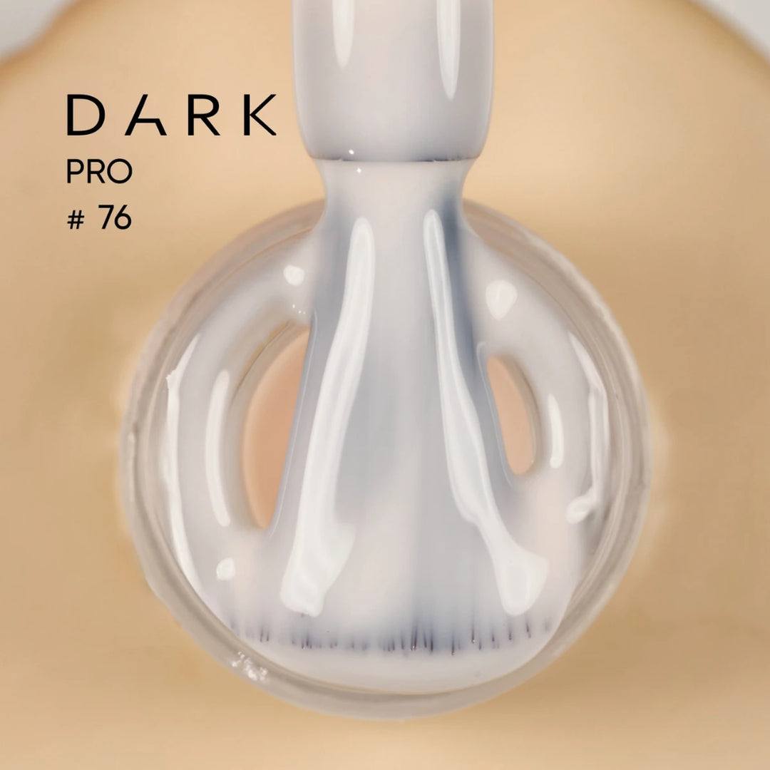 Close-up of a nail polish brush with white UV gel polish, labeled Dark Pro 