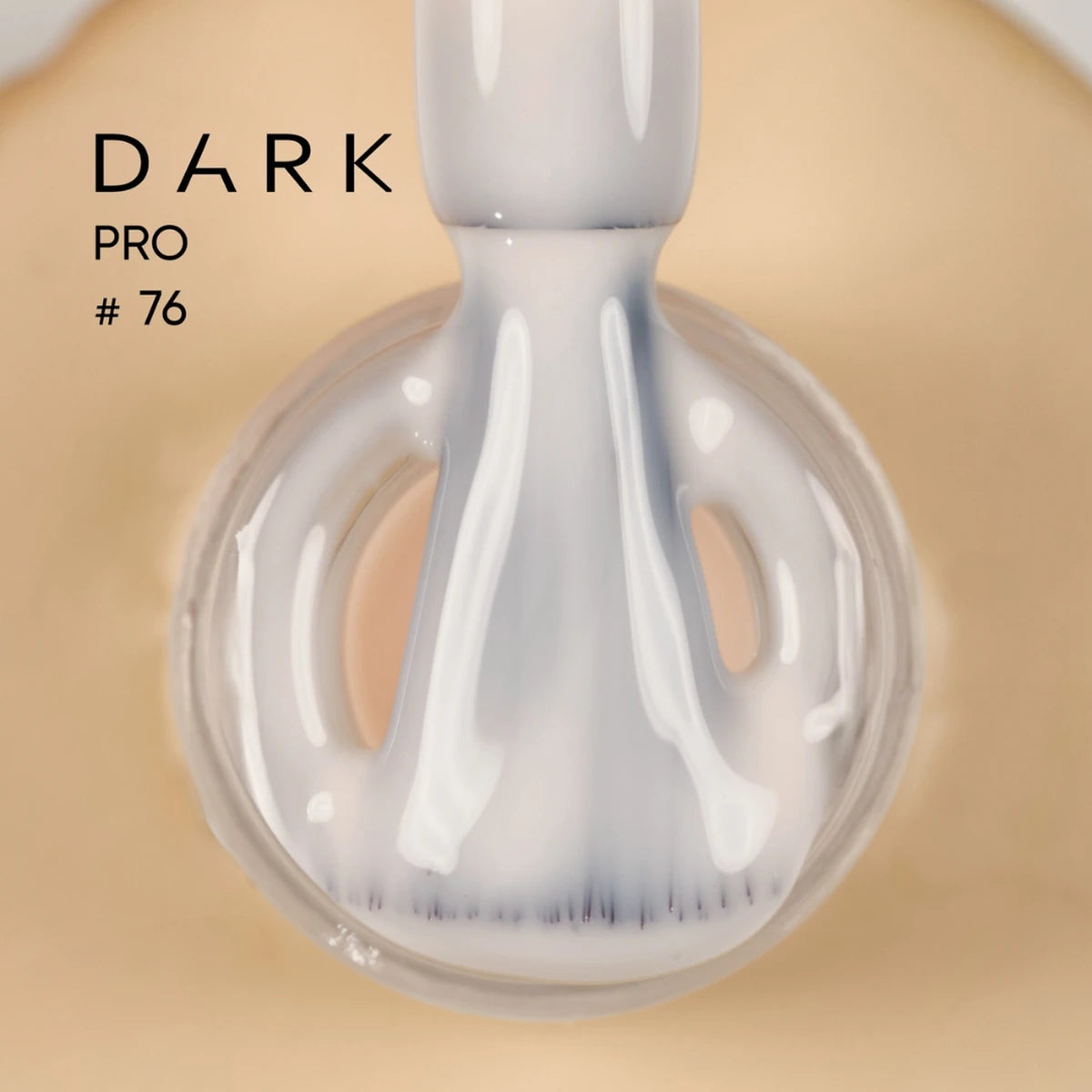 Close-up of a nail polish brush with white UV gel polish, labeled Dark Pro #76