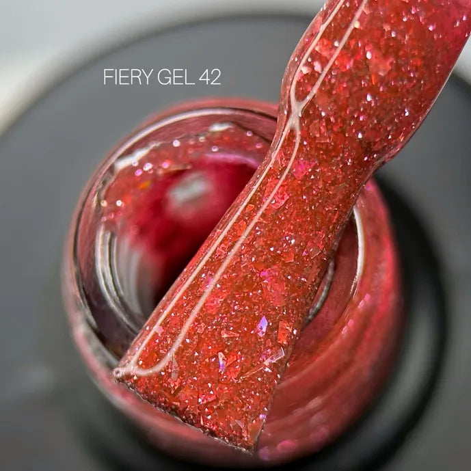 Close-up of Fiery Gel 42 red glitter UV gel nail polish with applicator brush