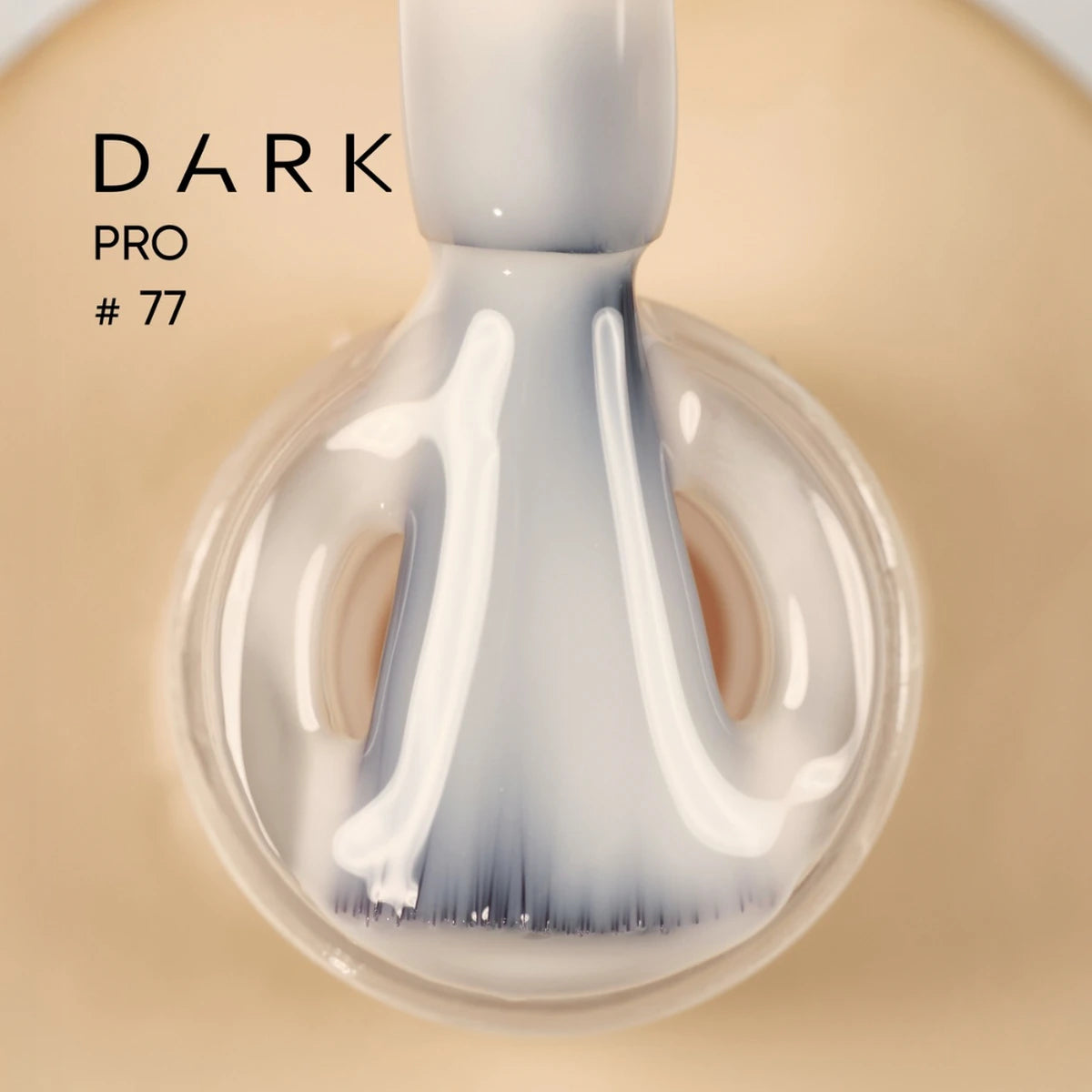 Beige gel nail polish brush applicator close-up, labeled DARK PRO #77, glossy finish