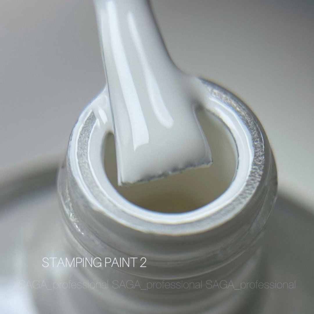White stamping nail paint brush and bottle for manicure and nail art close-up.