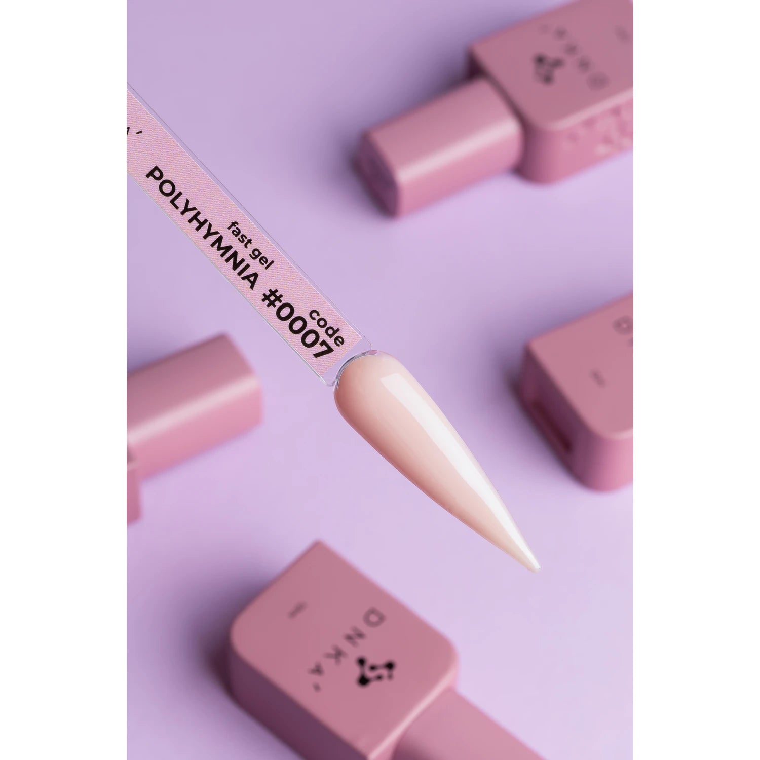 Creamy nude gel polish swatch labeled Polyhymnia #007 with pink nail polish bottles