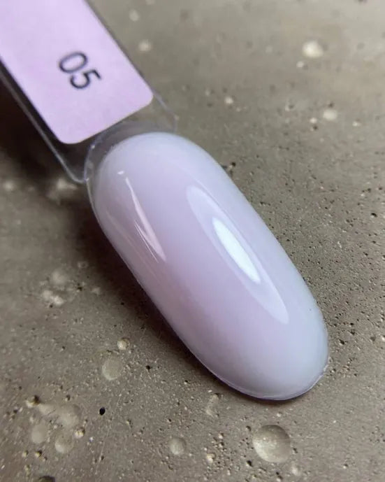 Swatch of light pink milky UV gel polish on nail sample stick, labeled 05.