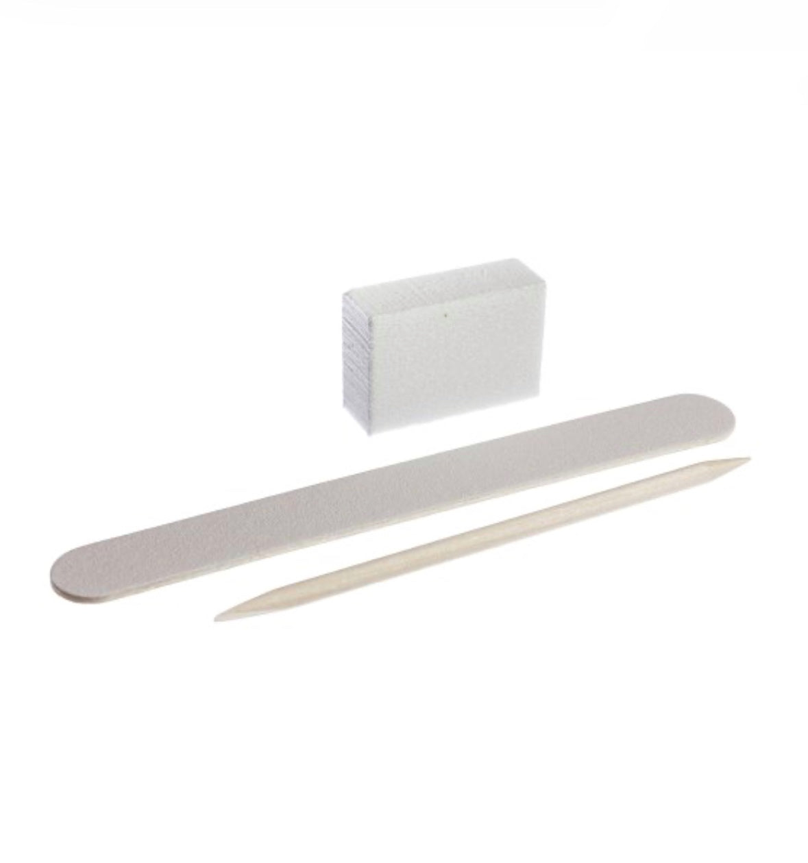 Manicure set with white nail file, wooden cuticle stick, and sanding buffer block on white background