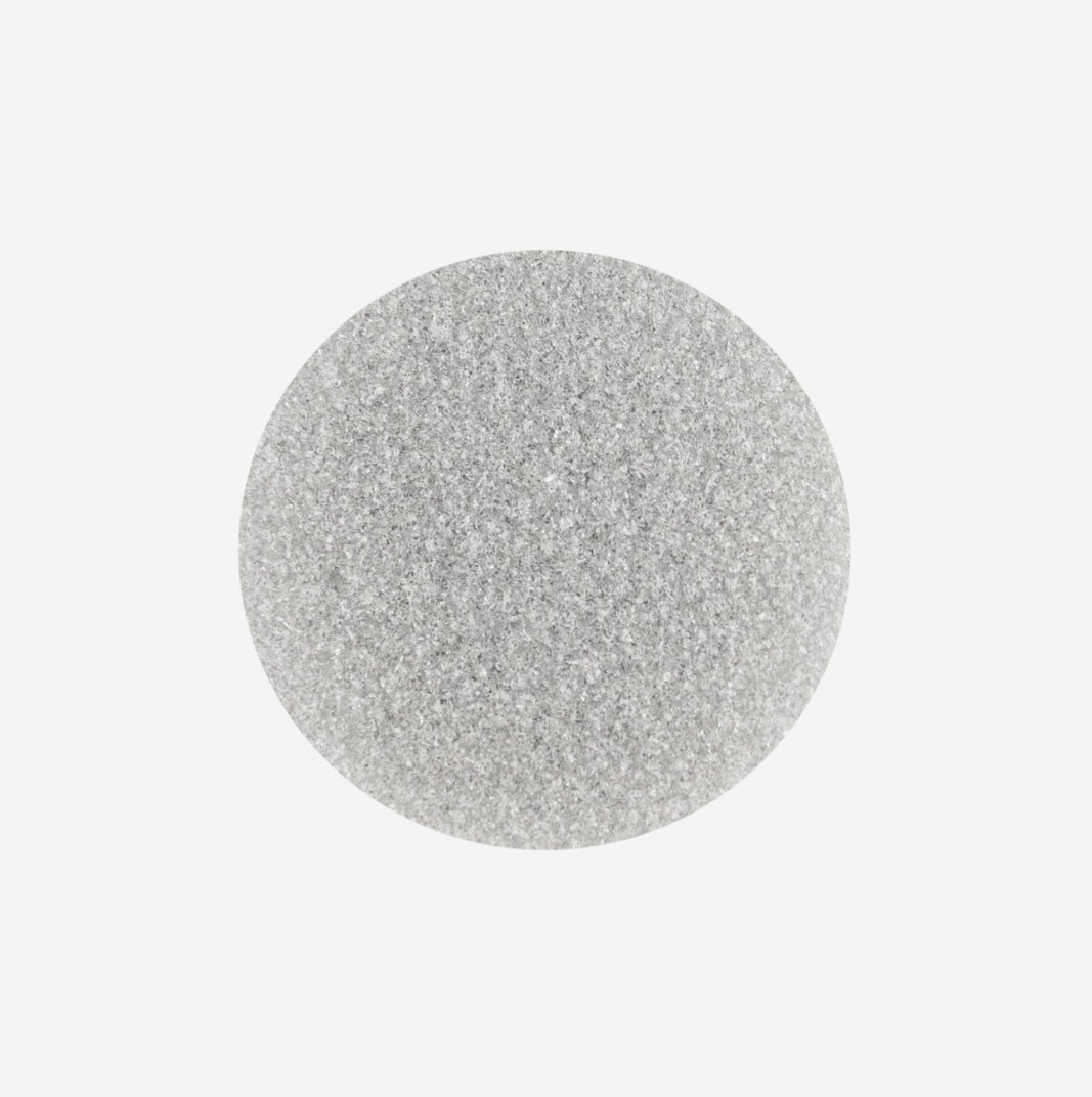 Round silver nail glitter powder for manicures and nail art decoration on white background