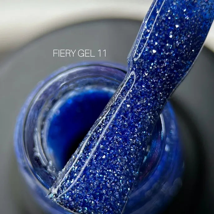 Blue glitter UV gel polish for nails, close-up of Fiery Gel 11 texture on applicator.