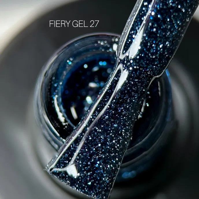 Close-up of Fiery Gel 27 dark blue glitter UV gel nail polish on applicator brush