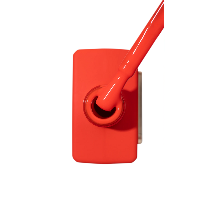 Bright red gel nail polish bottle with brush, professional manicure accessory
