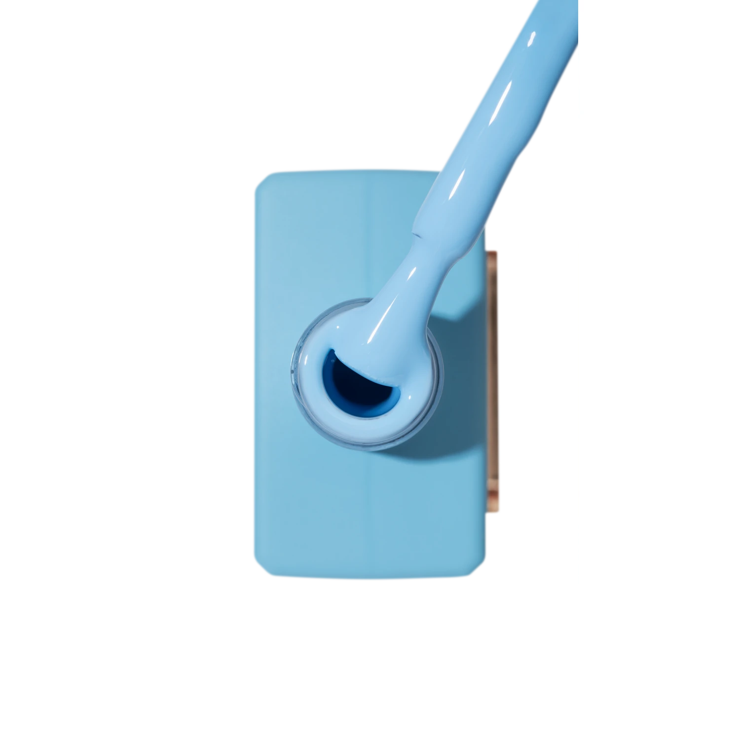 Light blue gel nail polish with brush, manicure product close-up
