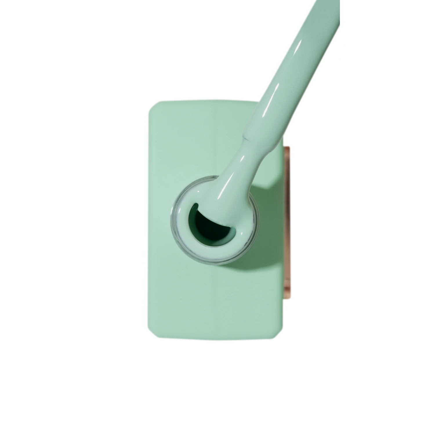 Mint green UV gel nail polish bottle with brush for manicure