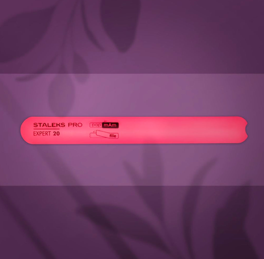 Pink Staleks Pro Expert 20 nail file for manicure on a purple background