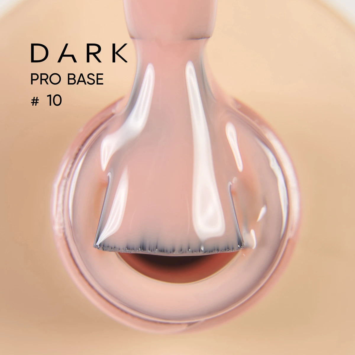Nude pink gel nail polish brush inside bottle, labeled DARK PRO BASE #10, manicure product