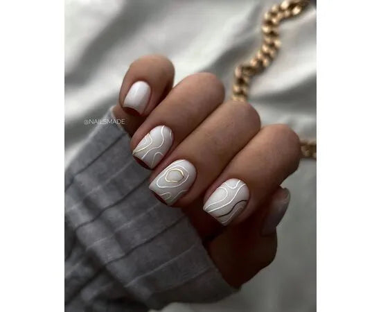 White gel manicure with gold abstract line nail art on short square nails