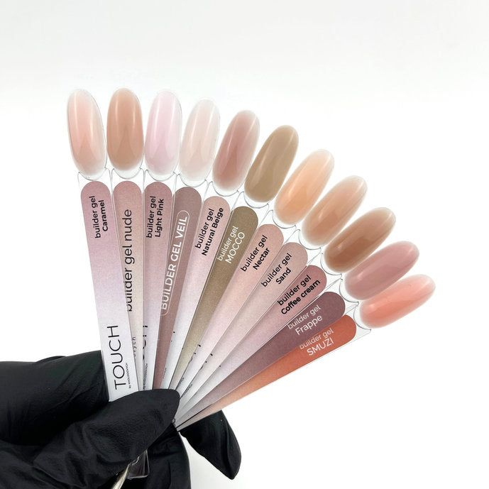 Fan of builder gel color swatches in nude and pink shades for professional manicure