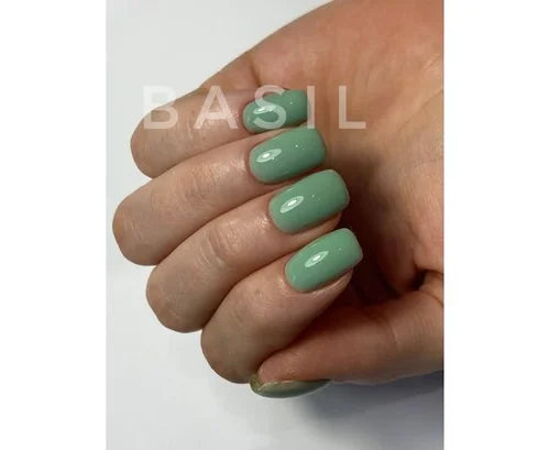 Hand with glossy basil green gel nail polish, short square manicure