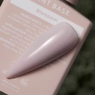 Blossom pink gel nail polish swatch on nail tip, soft pastel manicure color