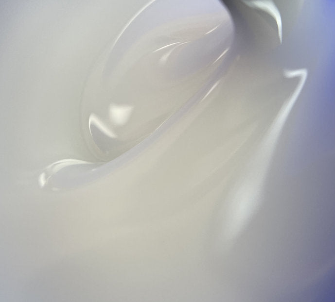 Close-up of translucent builder gel for nails with glossy, swirled texture