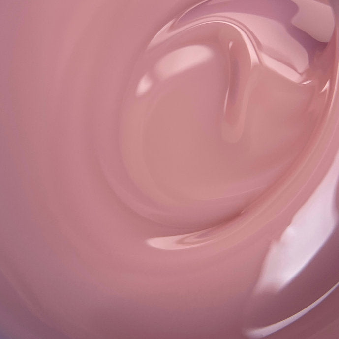 Close-up of pink builder gel for professional nail extension and manicure