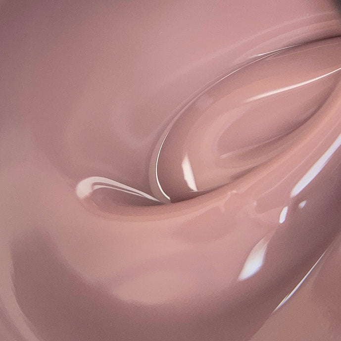 Close-up of nude pink builder gel for nails, glossy manicure product texture