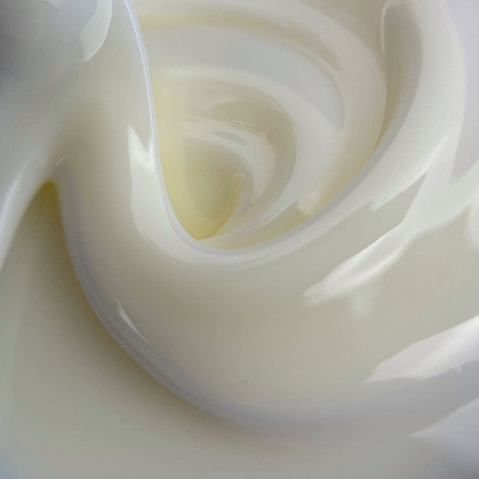 Milky white UV builder gel for nails, smooth creamy texture, manicure product closeup
