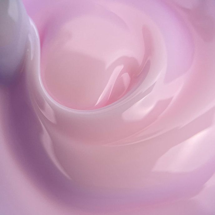 Swirl of light pink builder gel for nails, glossy texture, professional nail product