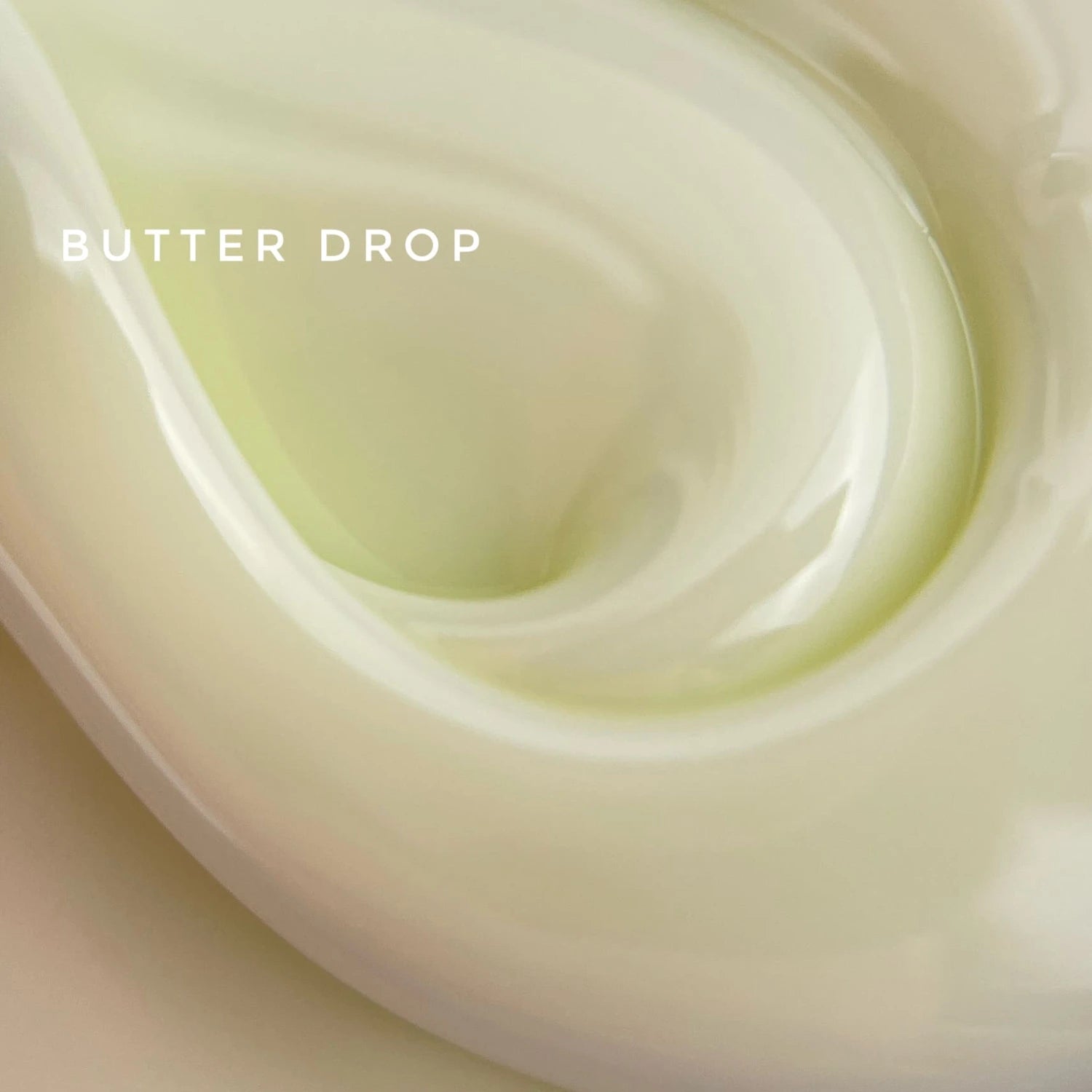 Swirl of creamy butter yellow nail gel labeled Butter Drop, smooth manicure product texture.