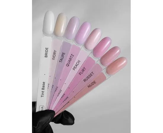 Tint base nail polish color swatches in nude, ivory, taupe, pink, and peach shades for manicure