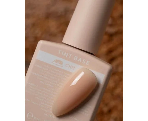 Nude tint base gel polish bottle with matching beige nail sample, manicure product