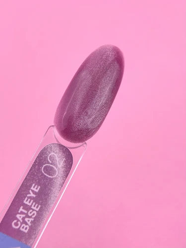 Cat eye base gel nail polish swatch in shimmering mauve on pink background