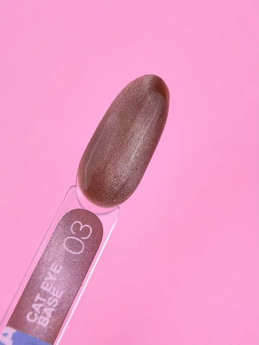 Brown cat eye gel nail polish swatch with shimmer on a pink background
