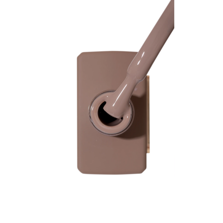 Beige nude gel nail polish bottle with brush for manicure