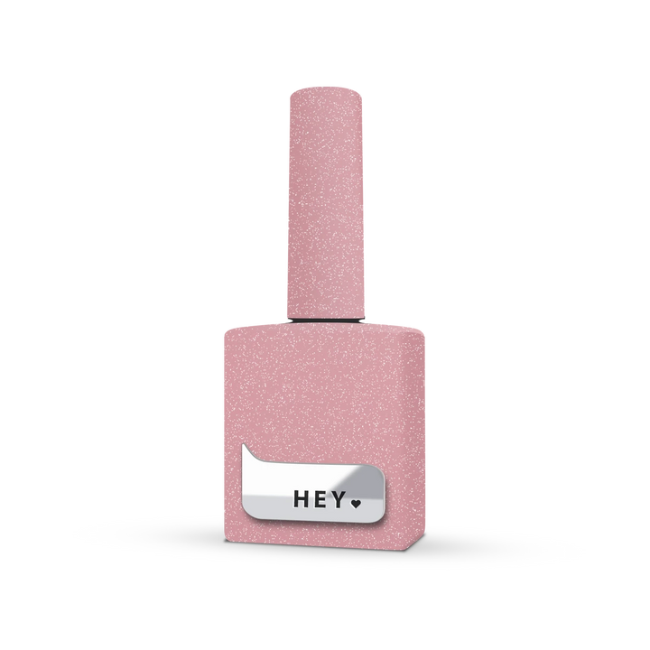 Pink glitter gel nail polish bottle with metallic HEY label, manicure product
