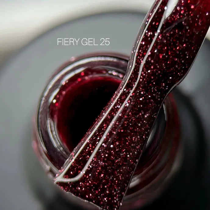 Close-up of a brush with glittery deep red UV gel nail polish, labeled Fiery Gel 25