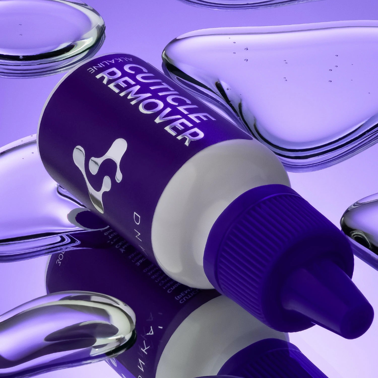 Alkaline cuticle remover bottle for manicure, purple cap, water droplets background