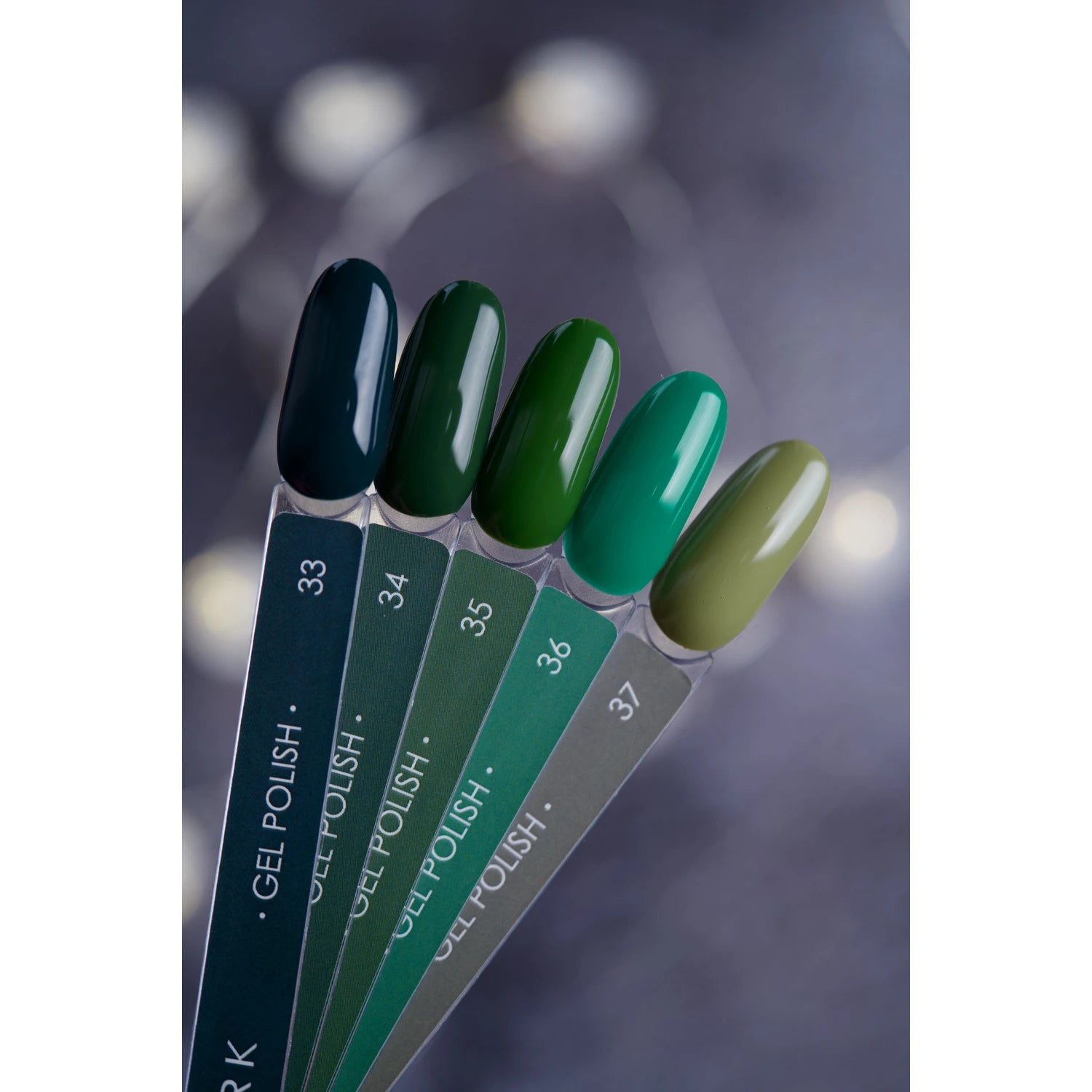 Green gel polish swatches for manicure, five shades displayed on sample sticks