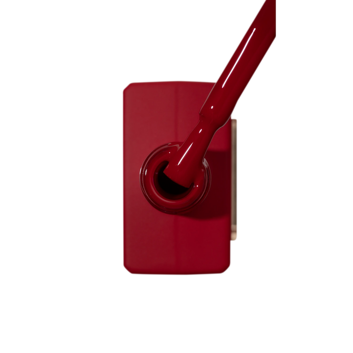 Red gel nail polish bottle with brush, professional manicure accessory