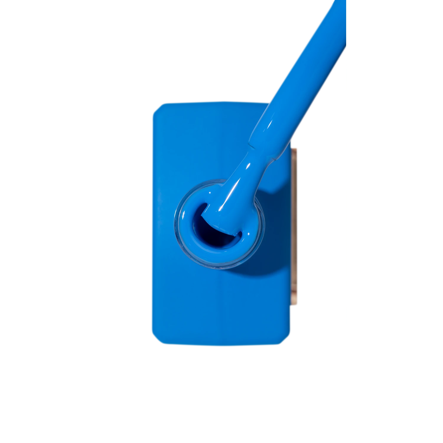 Bright blue UV gel nail polish bottle with brush applicator, professional manicure product