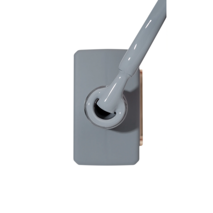 Grey nail polish bottle with brush applicator for manicure and pedicure