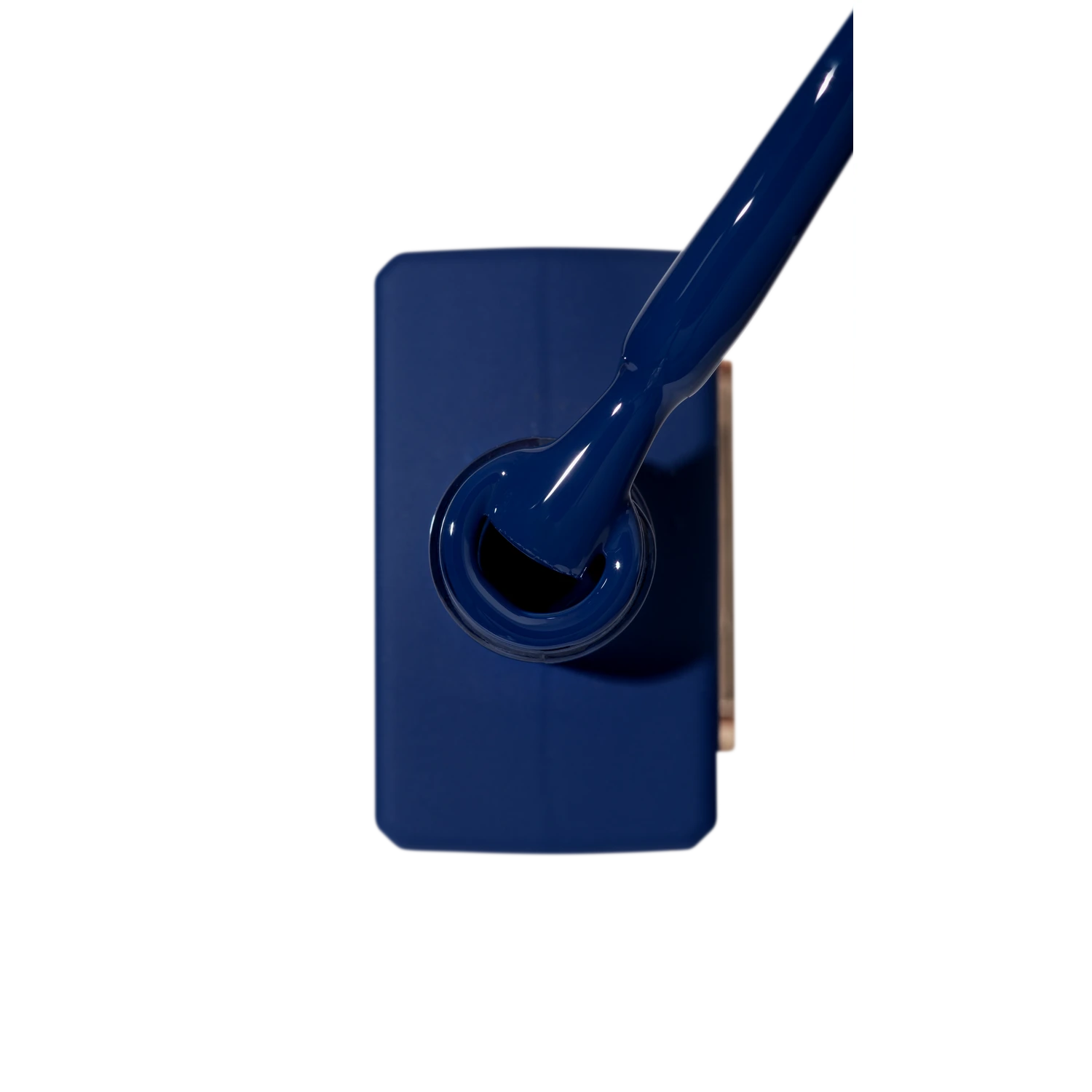 Blue gel nail polish bottle with applicator brush, manicure product close-up