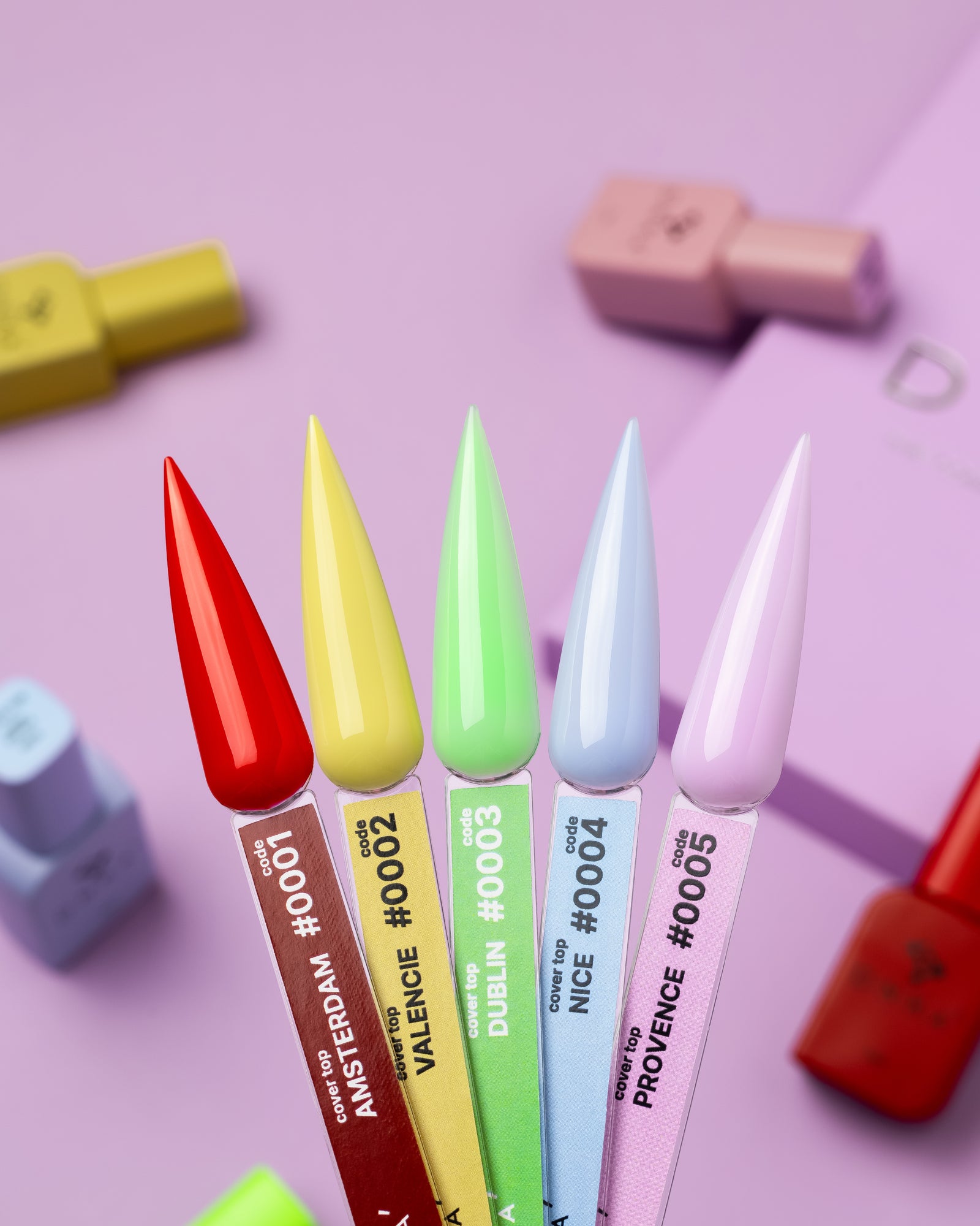 Colorful gel nail polish swatches in red, yellow, green, blue, and lilac on a pastel background