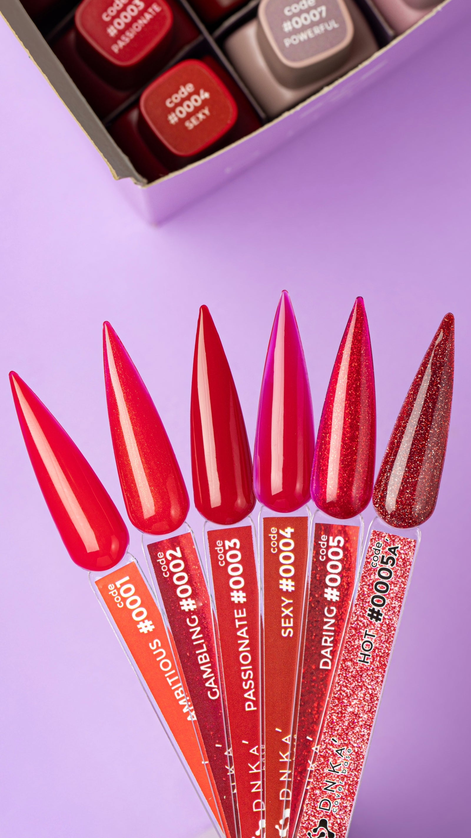 Red and pink nail gel polish color samples with glitter finish on lavender background
