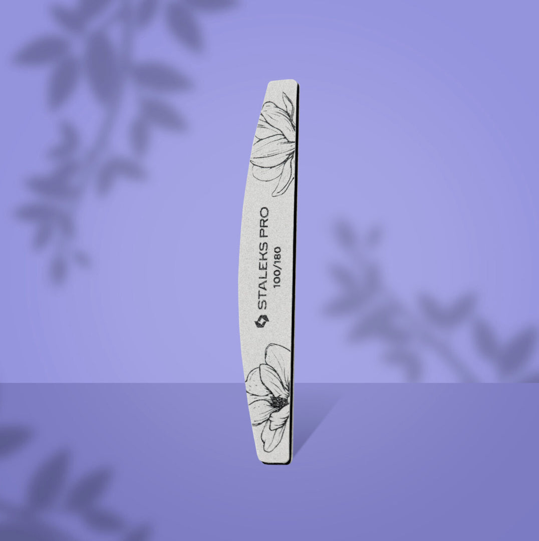 Curved nail file with floral design for professional manicure, Staleks Pro 100/180 grit on purple background