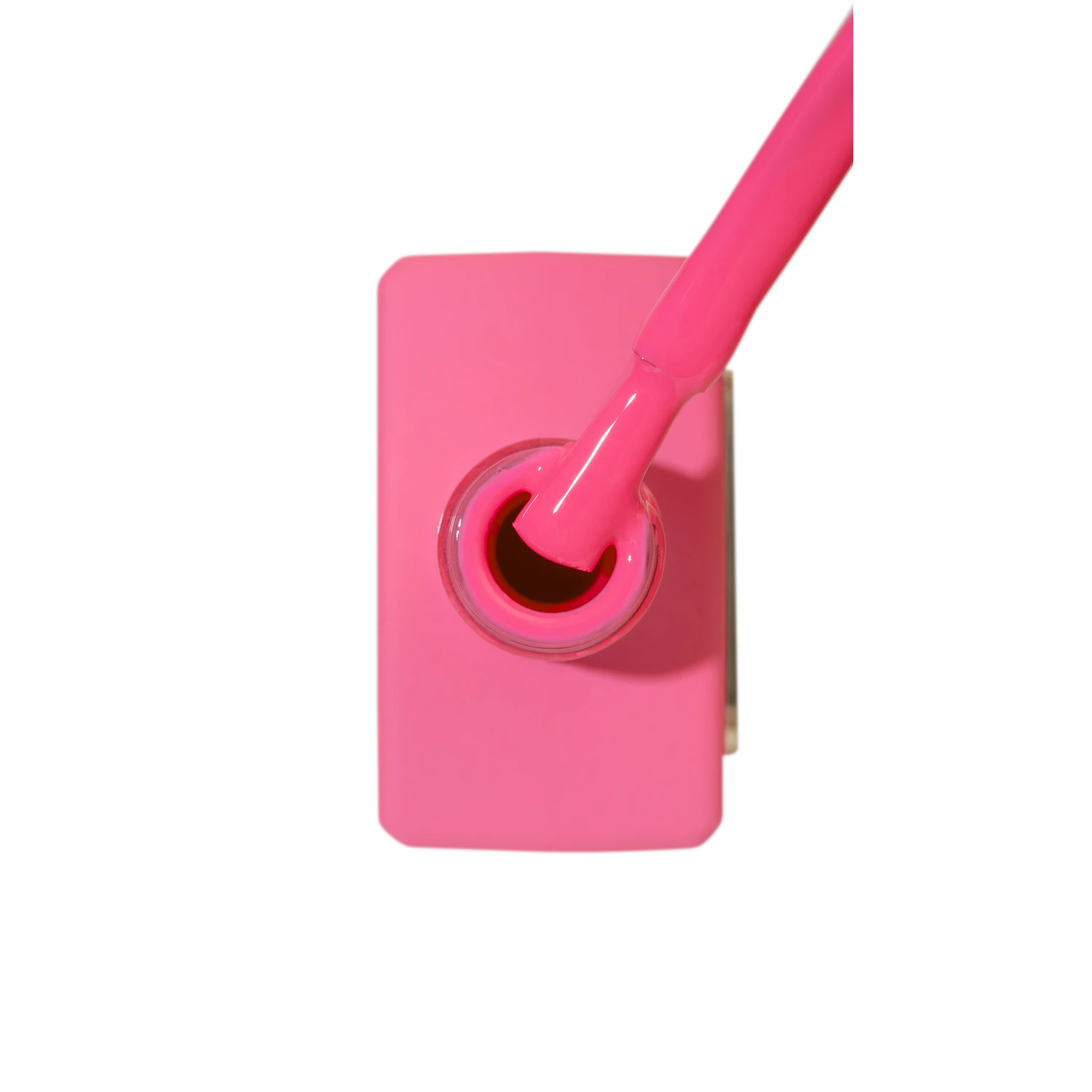 Bright fuchsia pink nail polish bottle with brush, manicure and nail art product