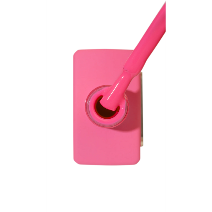 Bright fuchsia pink nail polish bottle with brush, manicure and nail art product