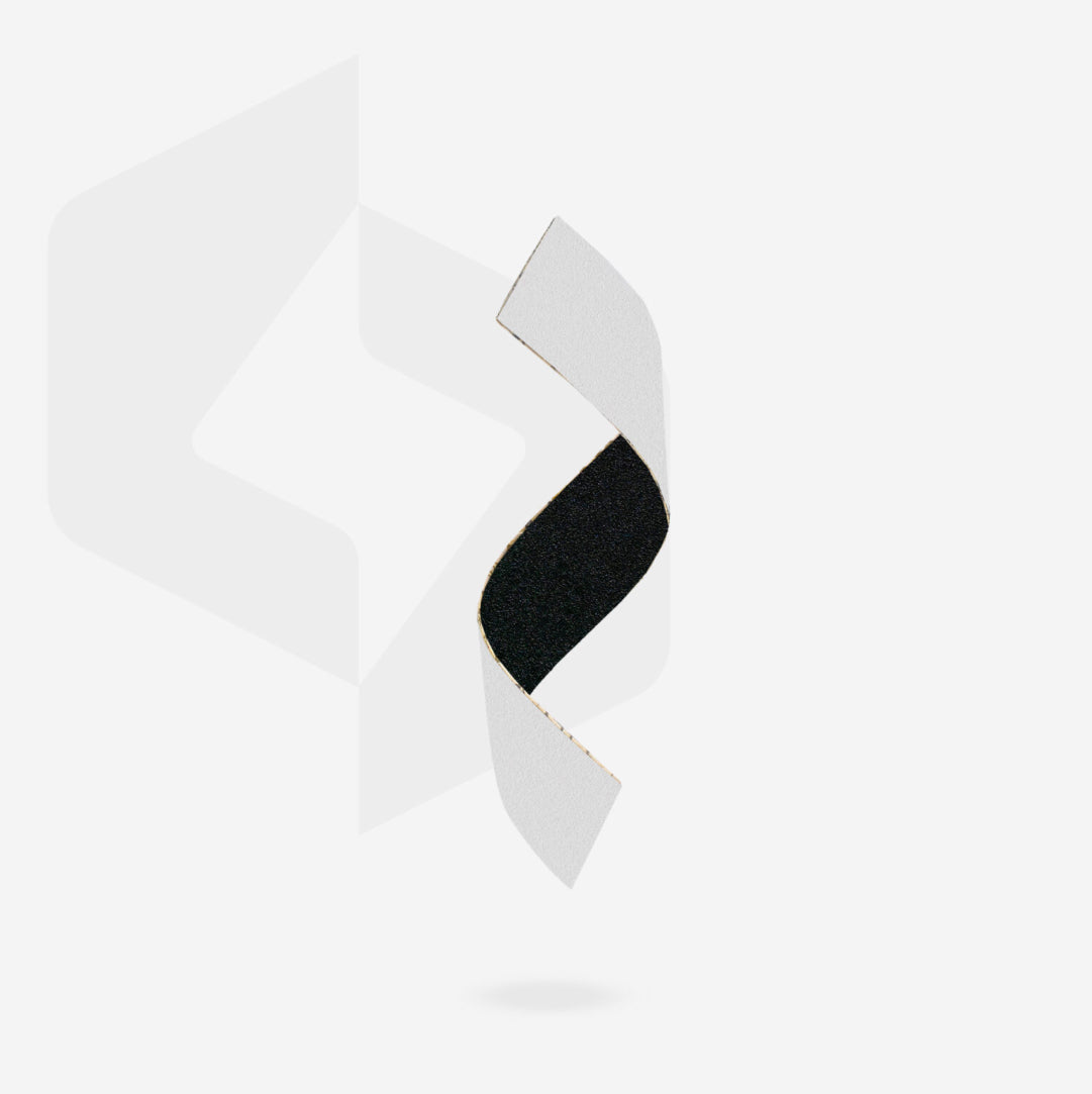 Curved black nail file abrasive strip with white backing for professional manicure