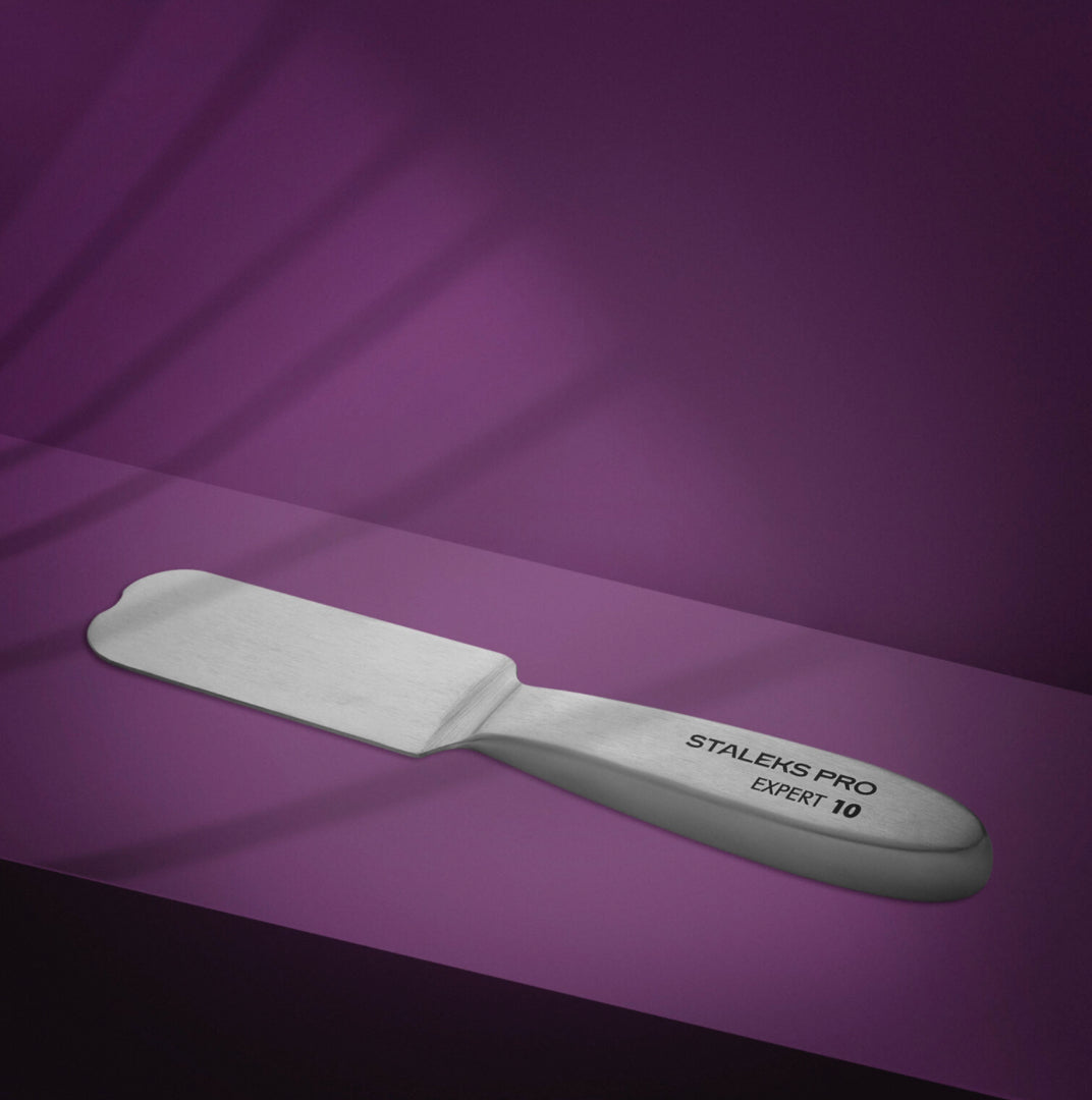 Stainless steel pedicure rasp for foot care on purple background, STALEKS PRO EXPERT 10